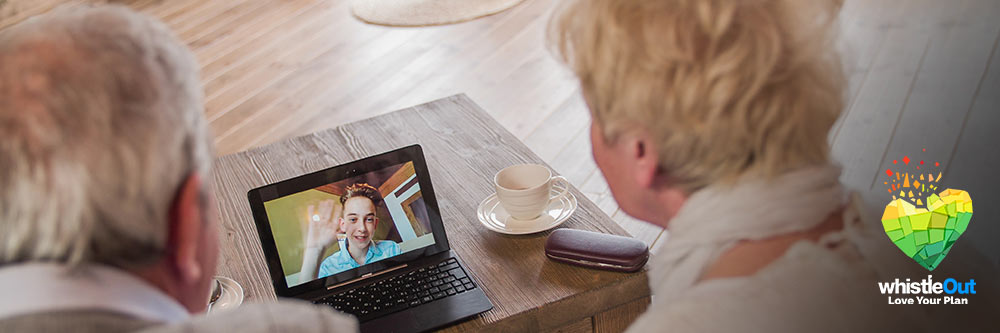 Elderly couple speaking to grandchild over video call