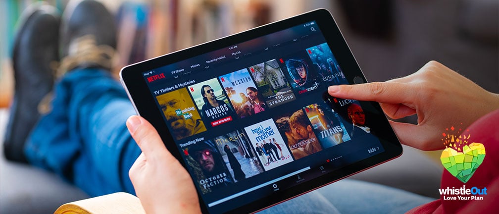 A person browsing Netflix shows on an iPad tablet